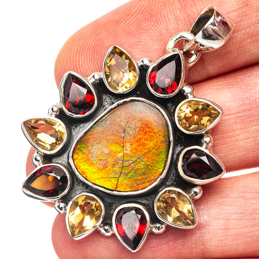 Iridescent ammolite pendant in silver with red, yellow, and clear teardrop gemstones