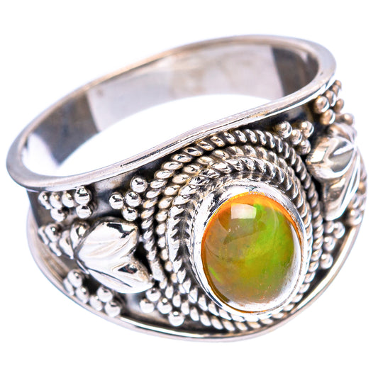 Sterling silver opal ring featuring oval green-orange opal and detailed beaded scrollwork setting