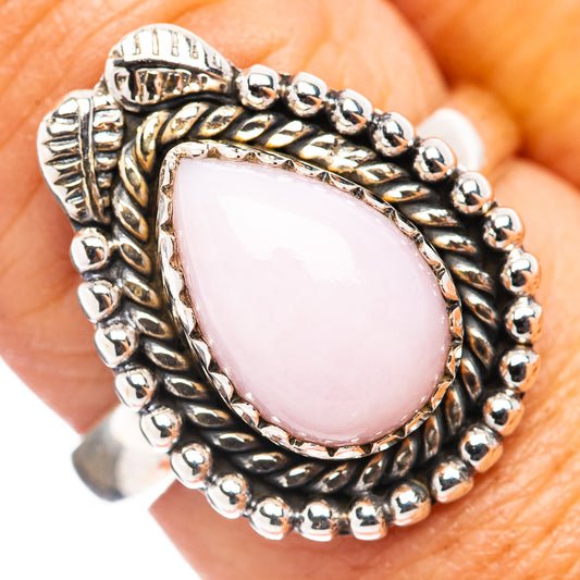 Sterling silver ring with oval pink opal centerpiece and beaded rope band detail
