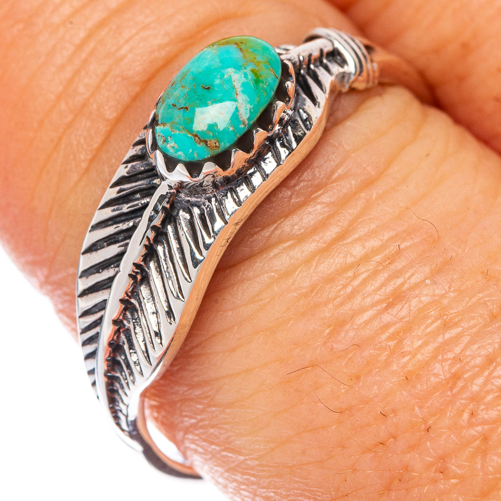 Turquoise cabochon feather ring in sterling silver, close-up on hand