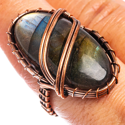 Oxidized copper wire-wrap ring with oval labradorite cabochon, on finger