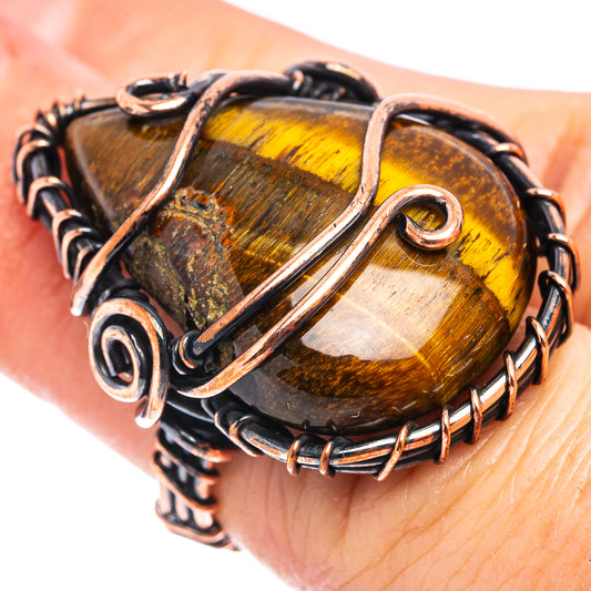 Oxidized copper wire-wrap ring with tiger-eye style amber oval gemstone