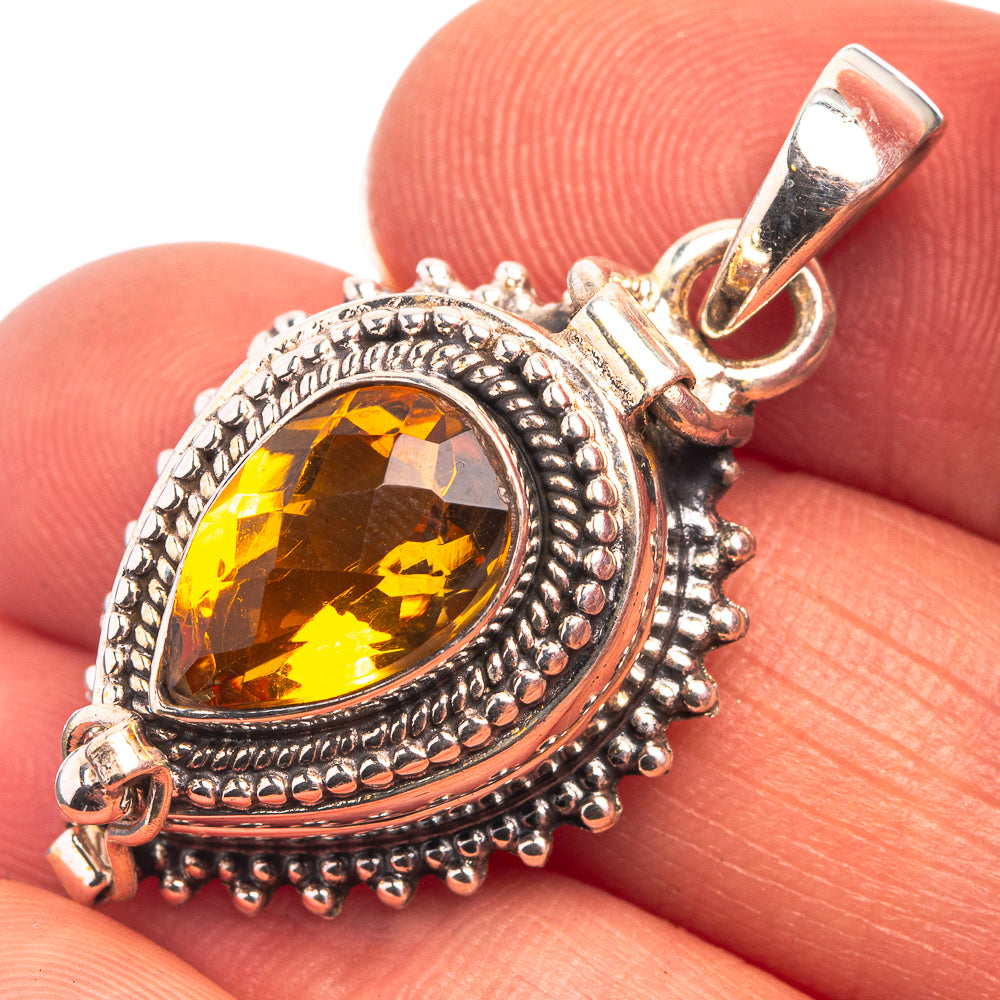 Amber gemstone pendant in sterling silver with ornate bezel and loop bail