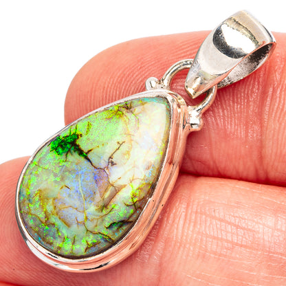 Sterling silver teardrop opal pendant close-up with polished bezel and rounded bail