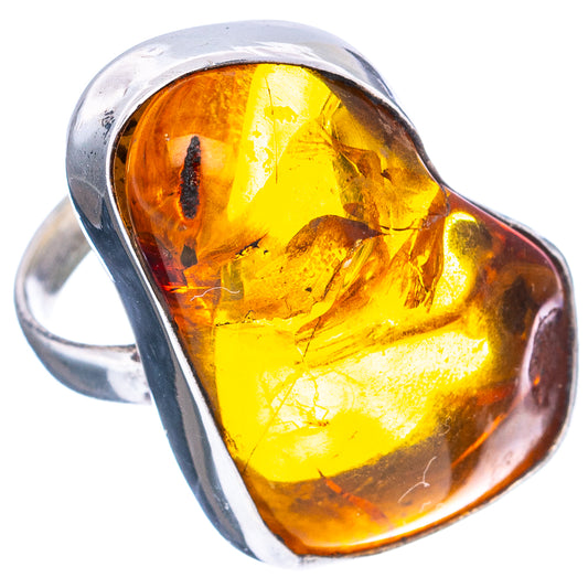 Close-up oval amber cabochon ring with .925 sterling silver band, golden yellow and amber tones