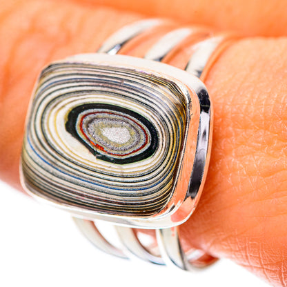 Sterling silver ring with oval fordite cabochon, concentric striped pattern, shiny bezel