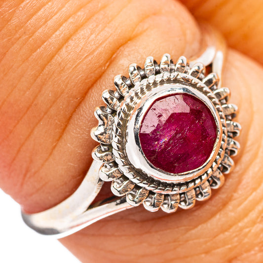 925 sterling silver ring on finger, oval red gemstone in spiked halo bezel