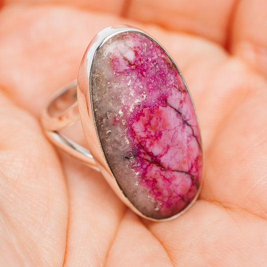 Oval cabochon gemstone ring showing pink veined stone in .925 sterling silver band