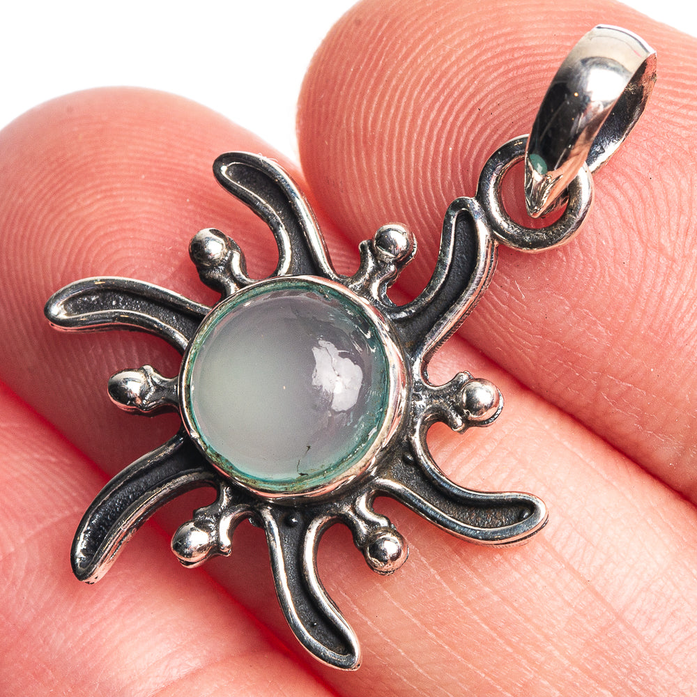 Sterling silver dainty pendant with round blue chalcedony cabochon and ornate floral frame