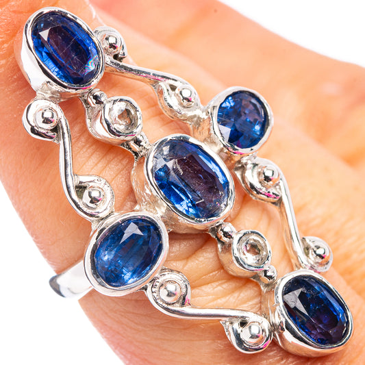 Sterling silver kyanite ring worn on finger, oval blue stones with small round halo settings
