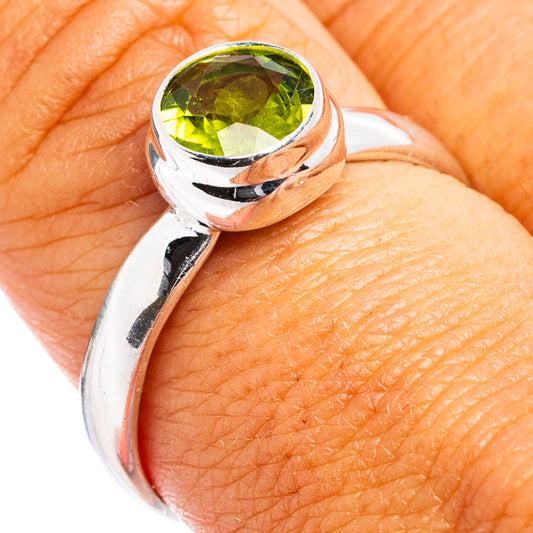 Faceted peridot ring, .925 sterling silver with round green stone bezel