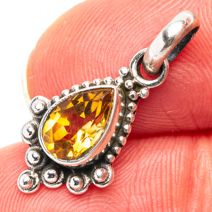 Sterling silver teardrop citrine pendant close-up on ornate scalloped bezel