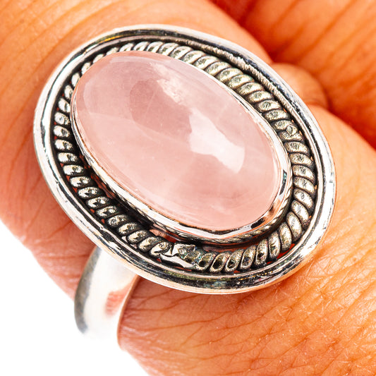 Oval rose quartz cabochon sterling silver ring with braided rope border