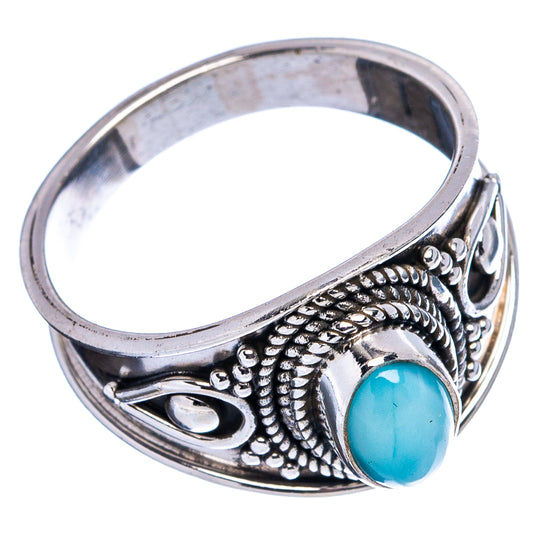 Sterling silver ring with blue oval gemstone and detailed floral rope pattern on band