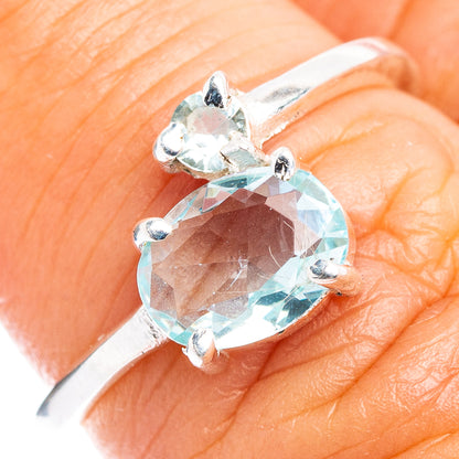 Sterling silver ring with faceted oval blue gemstone and four prongs, dainty band