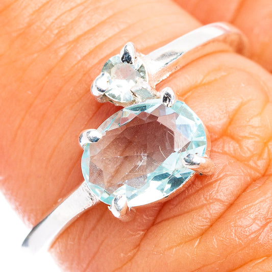 Sterling silver ring with faceted oval blue gemstone and four prongs, dainty band