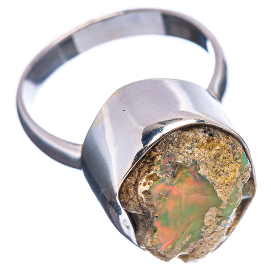 Sterling silver raw opal ring with green-orange stone, angled side view