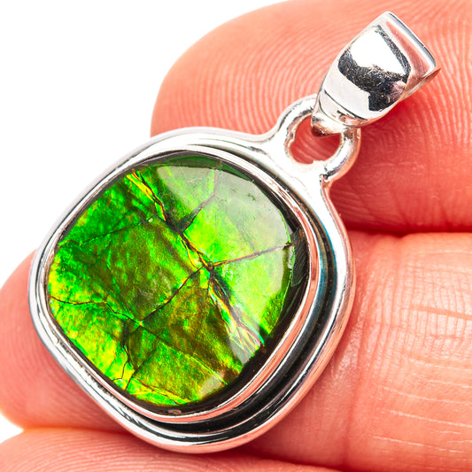 Sterling silver ammolite pendant with round green iridescent stone, close-up bail