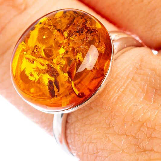 Adjustable oval amber ring with .925 sterling silver setting and warm honey amber stone
