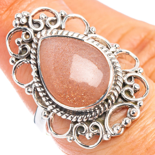 Sterling silver filigree ring with oval peach cabochon bezel