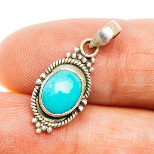 Turquoise oval sterling silver pendant with textured rope border and bail