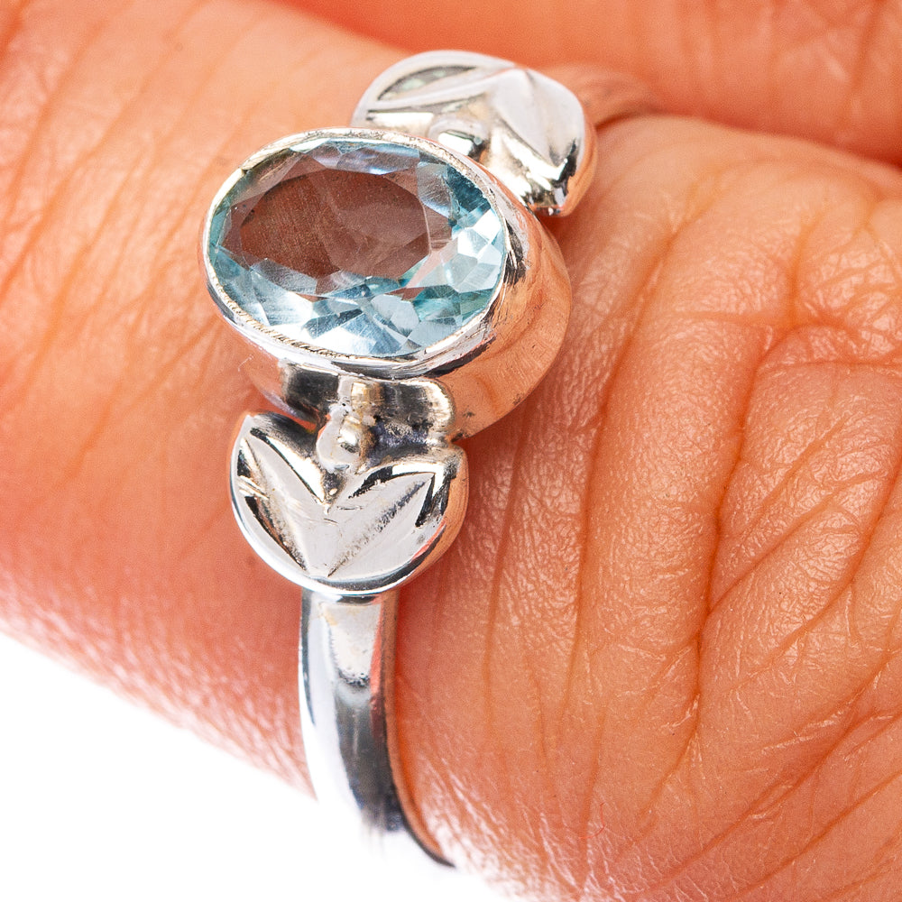 Sterling silver dainty ring with oval blue topaz and leaf-like setting