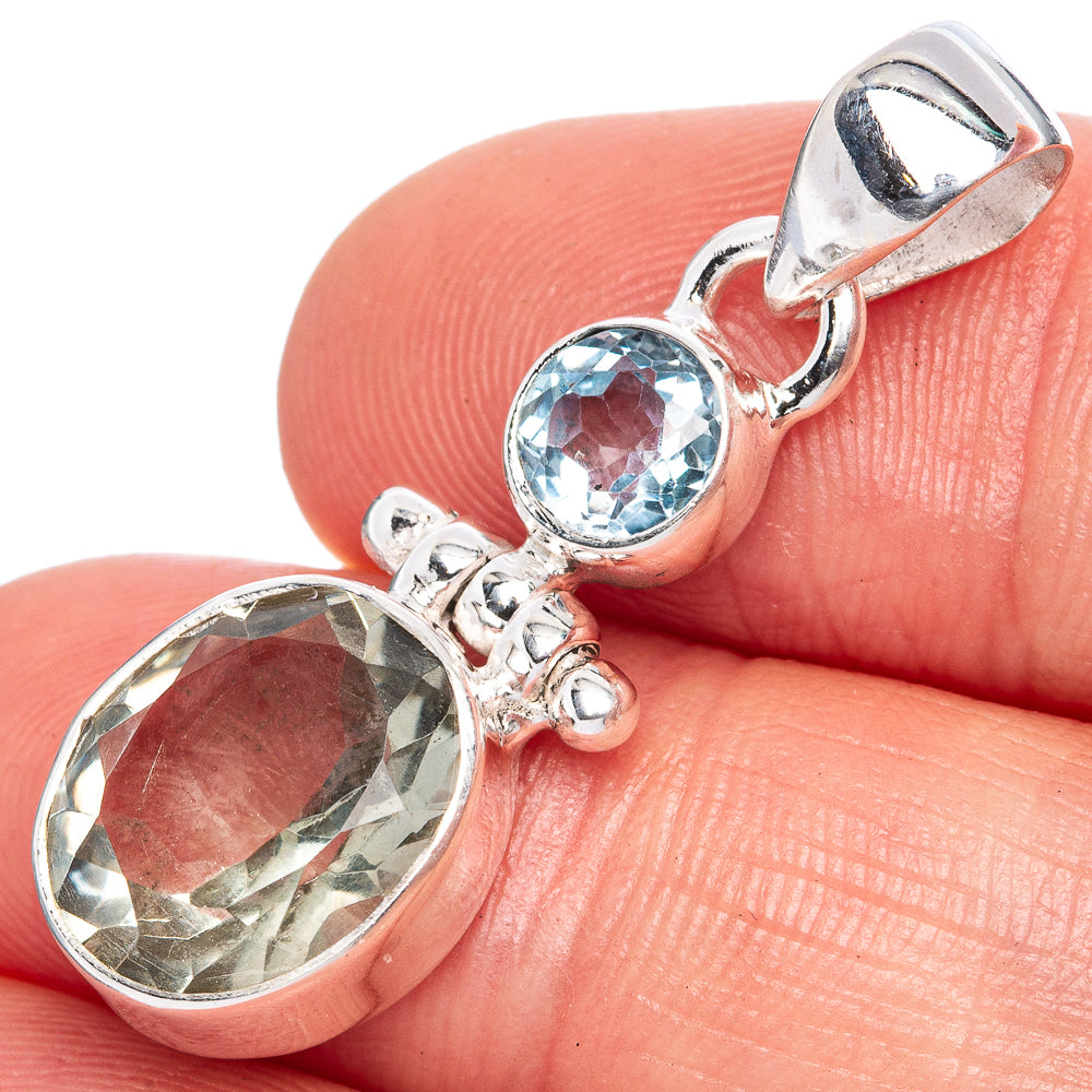 Sterling silver pendant with oval green amethyst and round blue topaz accent