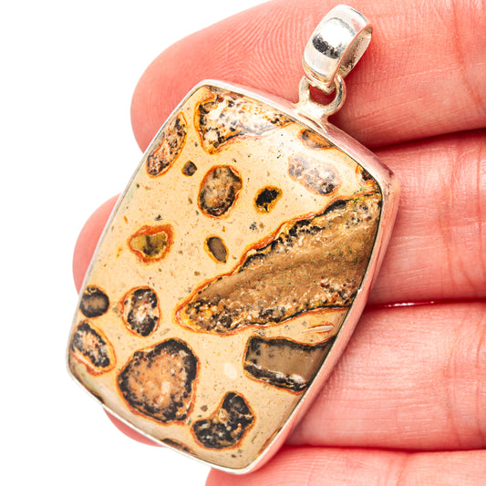 Leopardite jasper pendant with .925 sterling silver bail and textured stone face