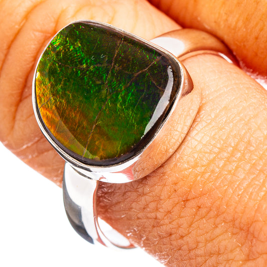 Sterling silver ammolite ring with green iridescent teardrop stone, close-up