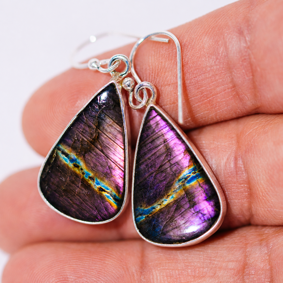 Sterling silver teardrop earrings with iridescent purple-blue stone