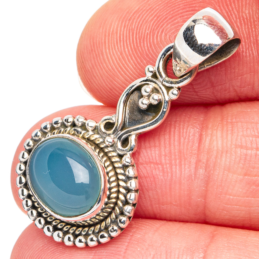 Aqua chalcedony pendant with round blue stone in ornate silver bezel
