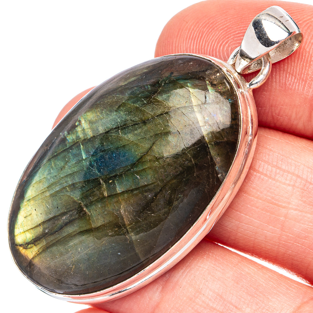 Oval labradorite pendant with dark green-blue flash, bezel set in sterling silver bail
