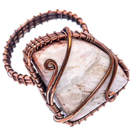 Oxidized copper wire-wrap ring with white tube agate centerpiece, open swirl detail