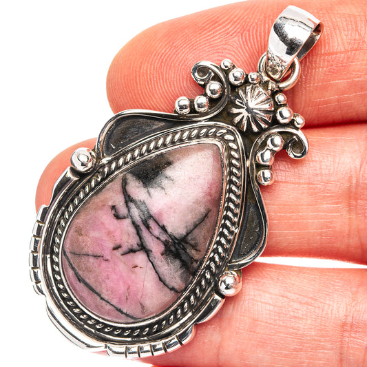 Rhodonite sterling silver pendant with ornate oval bezel and pink stone with dark veining