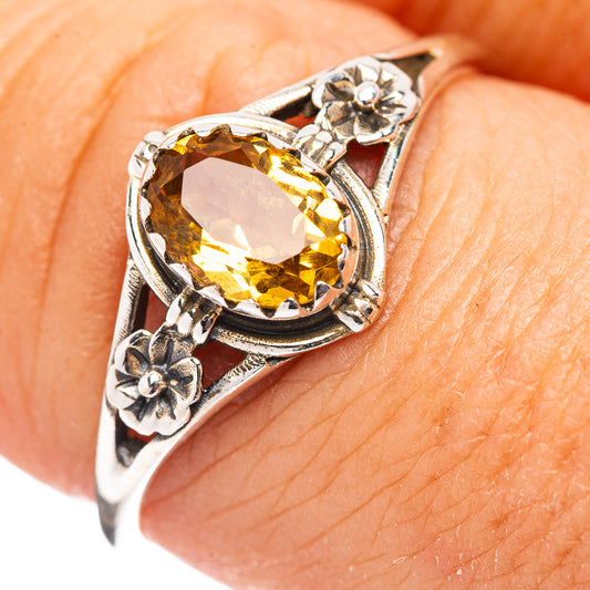 Sterling silver ring with oval yellow gemstone and floral side details