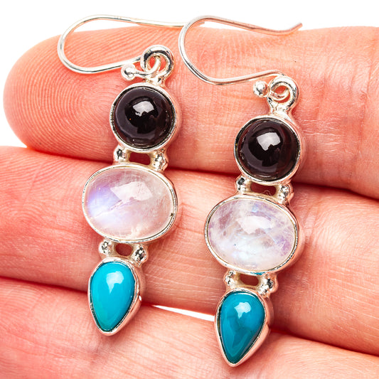 Sterling silver drop earrings with black round, rainbow moonstone, and blue teardrop stones
