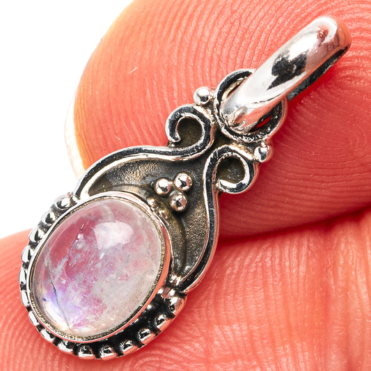 Close-up oval rainbow moonstone pendant in .925 sterling silver, ornate openwork setting