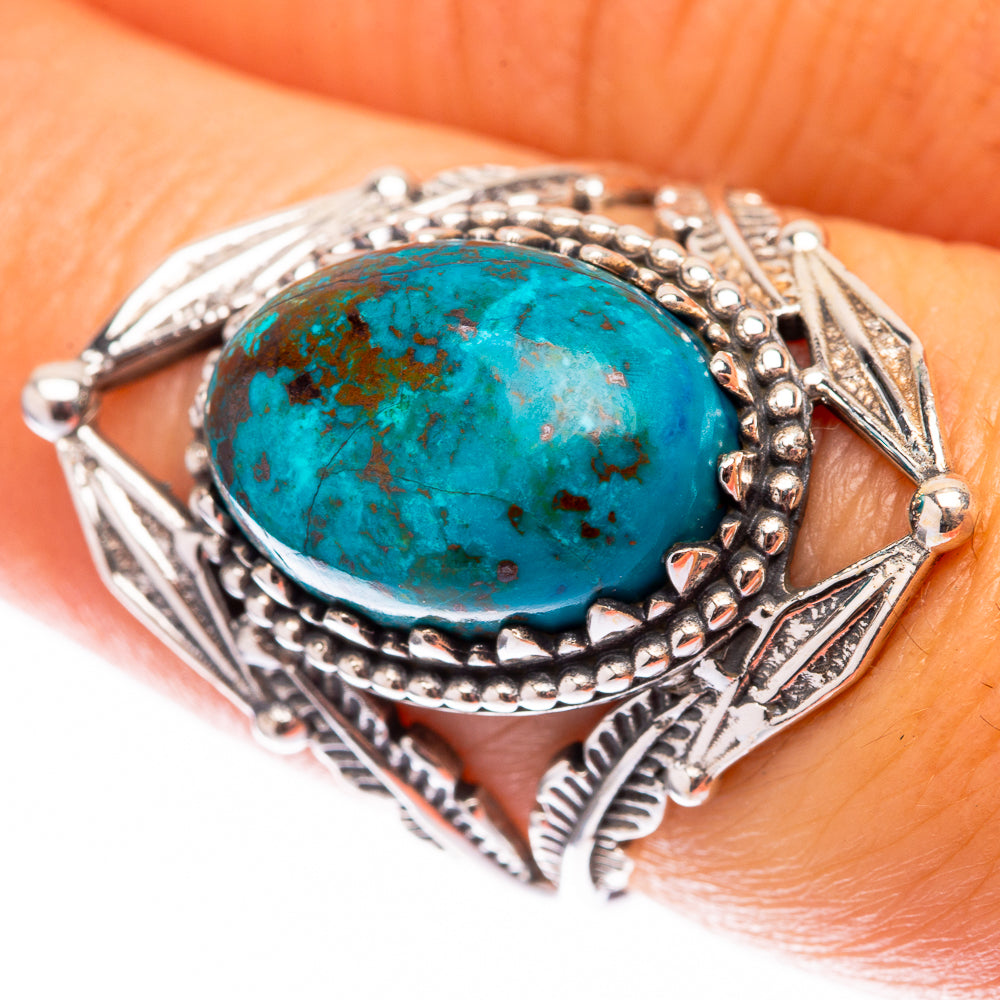 Sterling silver ring with oval turquoise cabochon and detailed bezel with side scrollwork