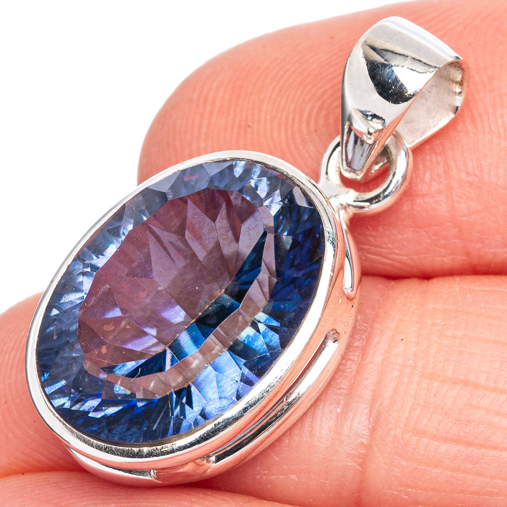 Oval blue gemstone pendant with sterling silver bezel and top bail, close-up detail