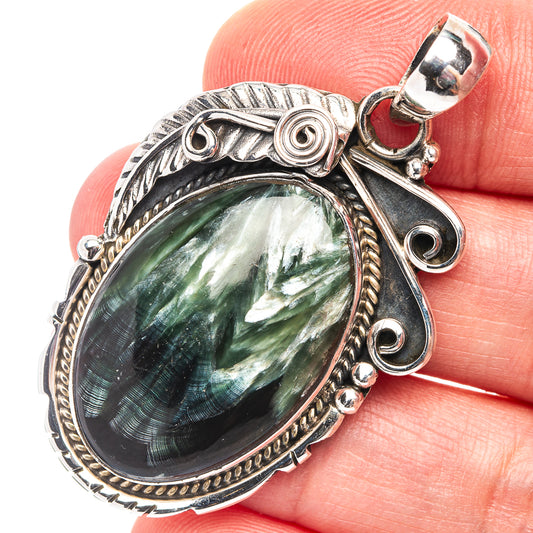 Oval seraphinite pendant in ornate .925 sterling silver bezel with bail