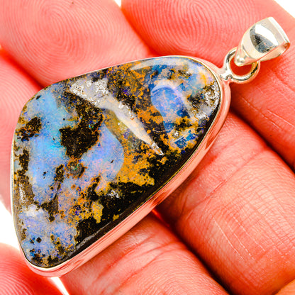 Sterling silver opal pendant in teardrop shape with blue and black stone detail