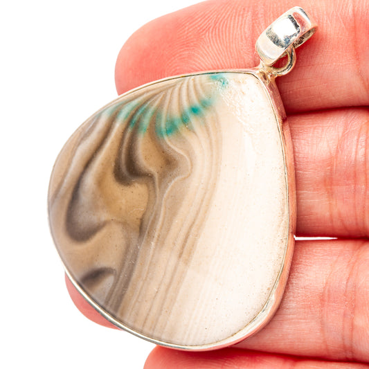 Teardrop flint pendant with banded stone pattern, silver bail held in hand