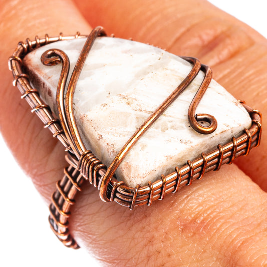 Oxidized copper wire-wrap ring with white tube agate on finger, textured band and swirls