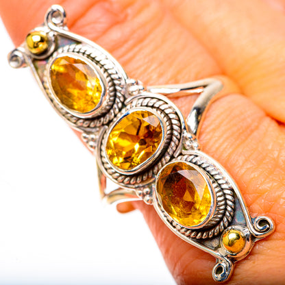Ornate silver ring with three oval faceted citrine stones and small yellow accents