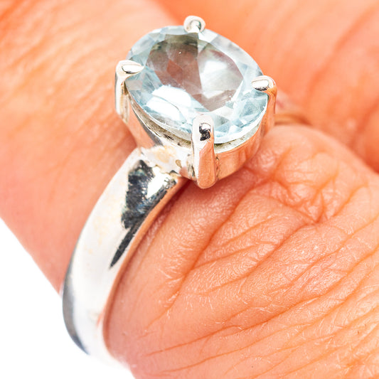 Sterling silver ring with faceted blue topaz centerpiece in prong setting