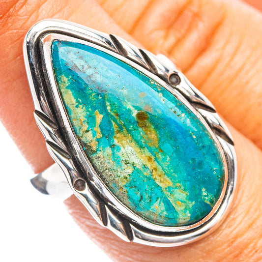 Sterling silver opal ring with oval turquoise stone and engraved bezel, close-up