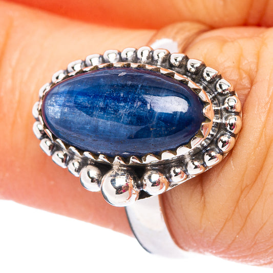 Sterling silver kyanite ring with oval blue stone and bead-set halo band