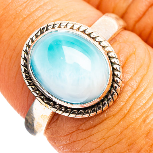 Sterling silver ring with oval turquoise cabochon and braided edge detail