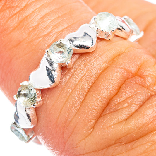 Dainty .925 sterling silver ring with light blue gemstone accents on finger