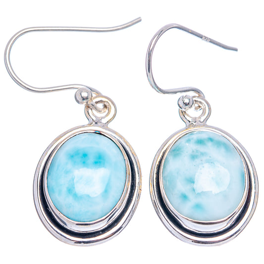 Sterling silver fishhook Larimar drop earrings with blue oval cabochon and oval frame.